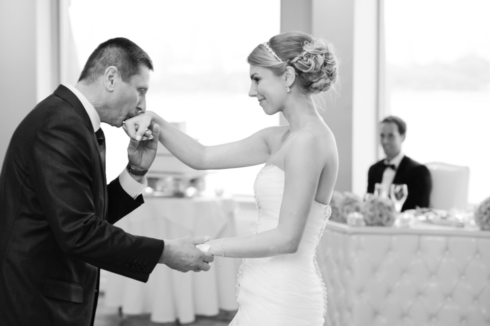 Very romantic photo of the father of the bride kissing the bride's hand.